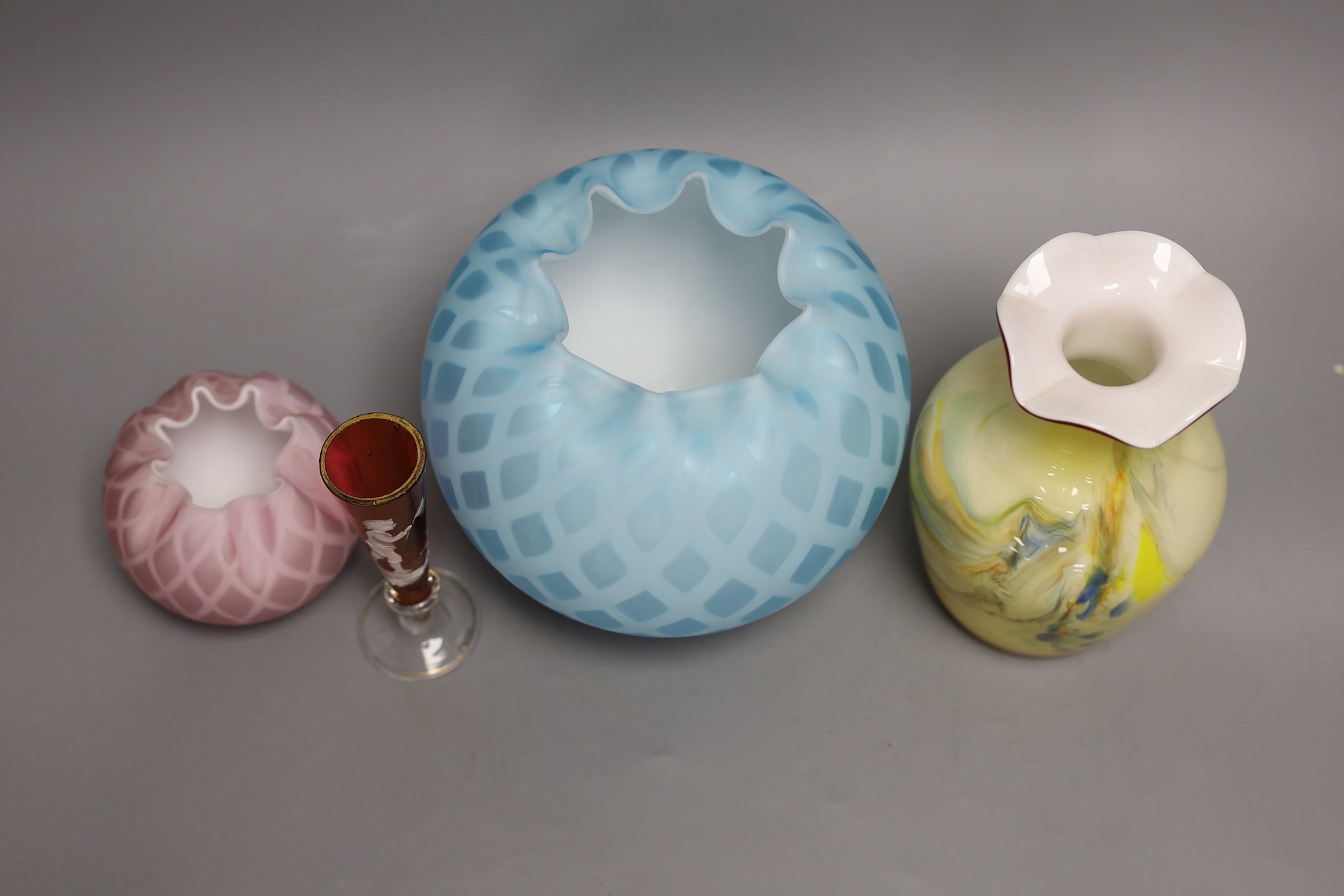 A pale blue quilted glass vase, another, smaller, in pink, a “Mary Gregory’’ vase and a yellow ground ‘’end of day’’ glass vase (4), tallest 16cm
